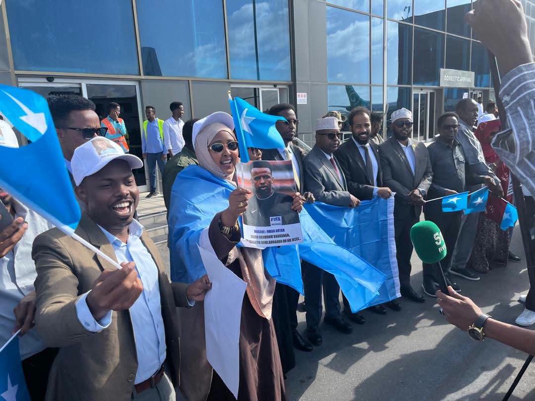 SompaSportsZone's tweet photo. 🇸🇴 INSPIRING SCENES: Somali referee Omar Abdulkadir Artan has received a massive hero's welcome upon returning home (Mogadishu) after being turned away by US authorities ahead of World Cup activities. 🇺🇸

​Far from breaking his momentum, the setback has heavily boosted his status https://t.co/nLqyBFY6EG