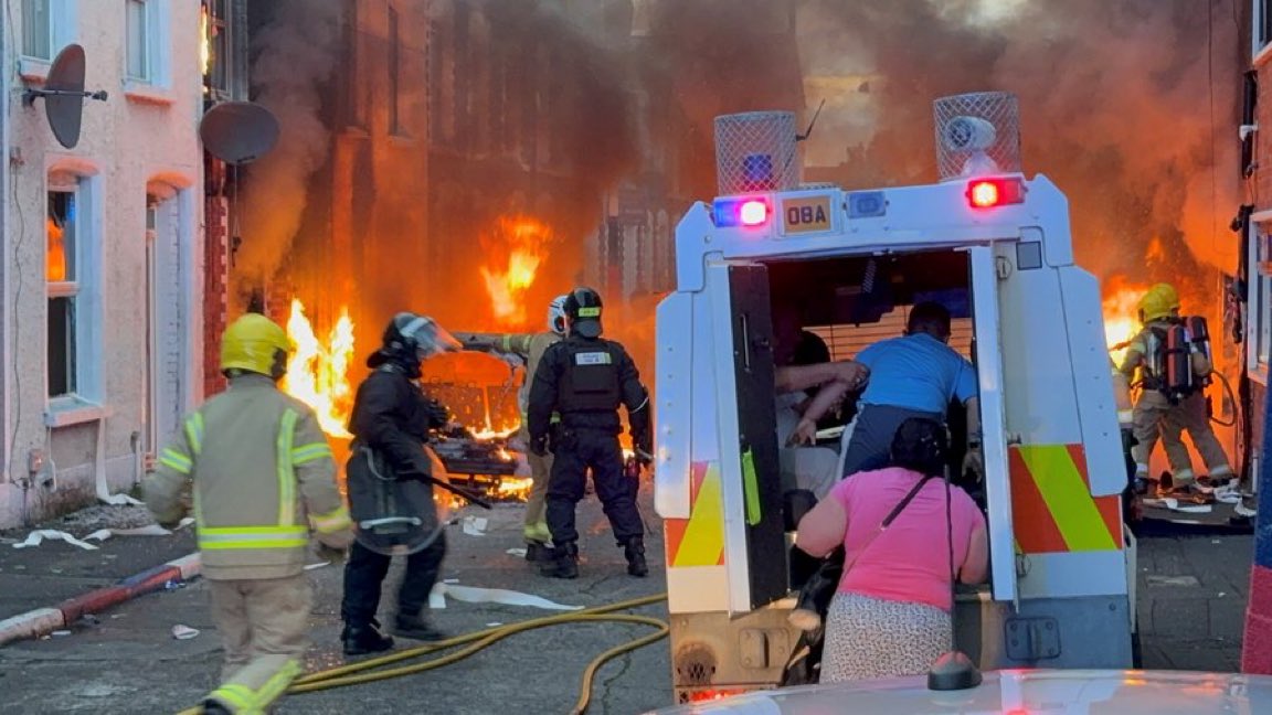 Heccles94's tweet photo. A family fleeing for their lives as far right thugs burn their house, egged on by GB News and Tommy Robinson. 

This is terrorism. https://t.co/K5eRZtnkYt