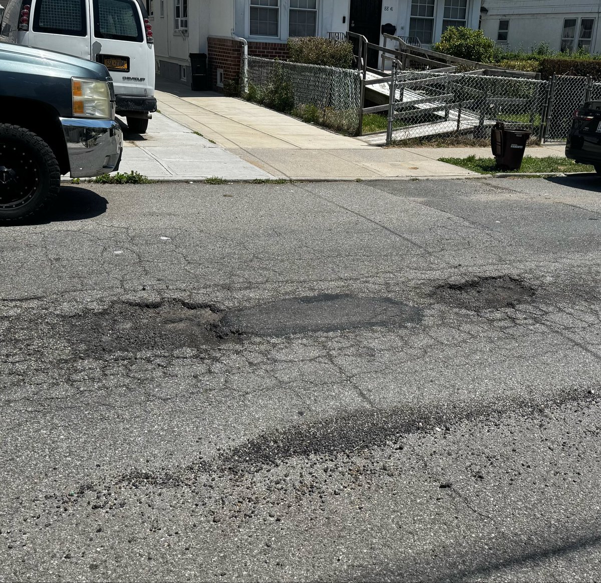 raylincoln's tweet photo. Reported potholes weeks ago. DQ2026133037. 311 said these holes were filled but that is false. Fill them DOT! @NYC_DOT @nyc311 @NYCMayor https://t.co/lAQkFLdYIt