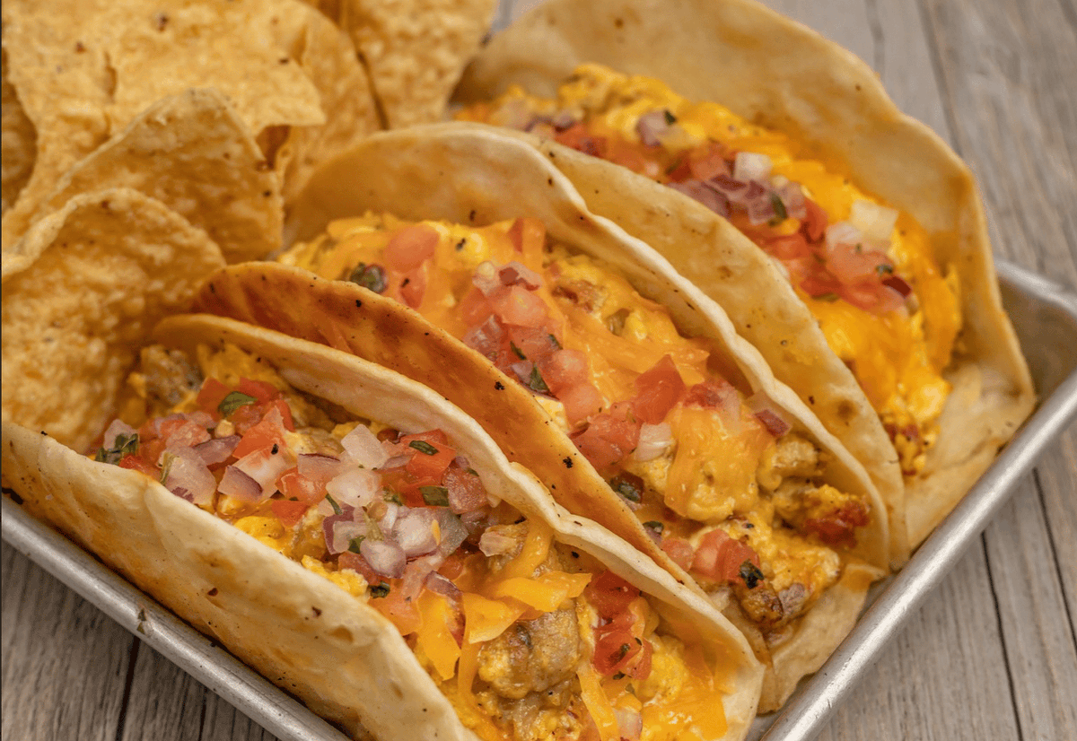 Tables_Taps's tweet photo. Taco-licious Morning is one of the most-loved picks at Tables and Taps 🌮 Three flour tortillas loaded with your choice of bacon or sausage, Bloody Mary salsa, pico de gallo, scrambled eggs, Cheddar, plus chips &amp; queso. 😋 #TablesAndTaps #BrunchFavorites #TacoLiciousMorning https://t.co/cv94WaIB58