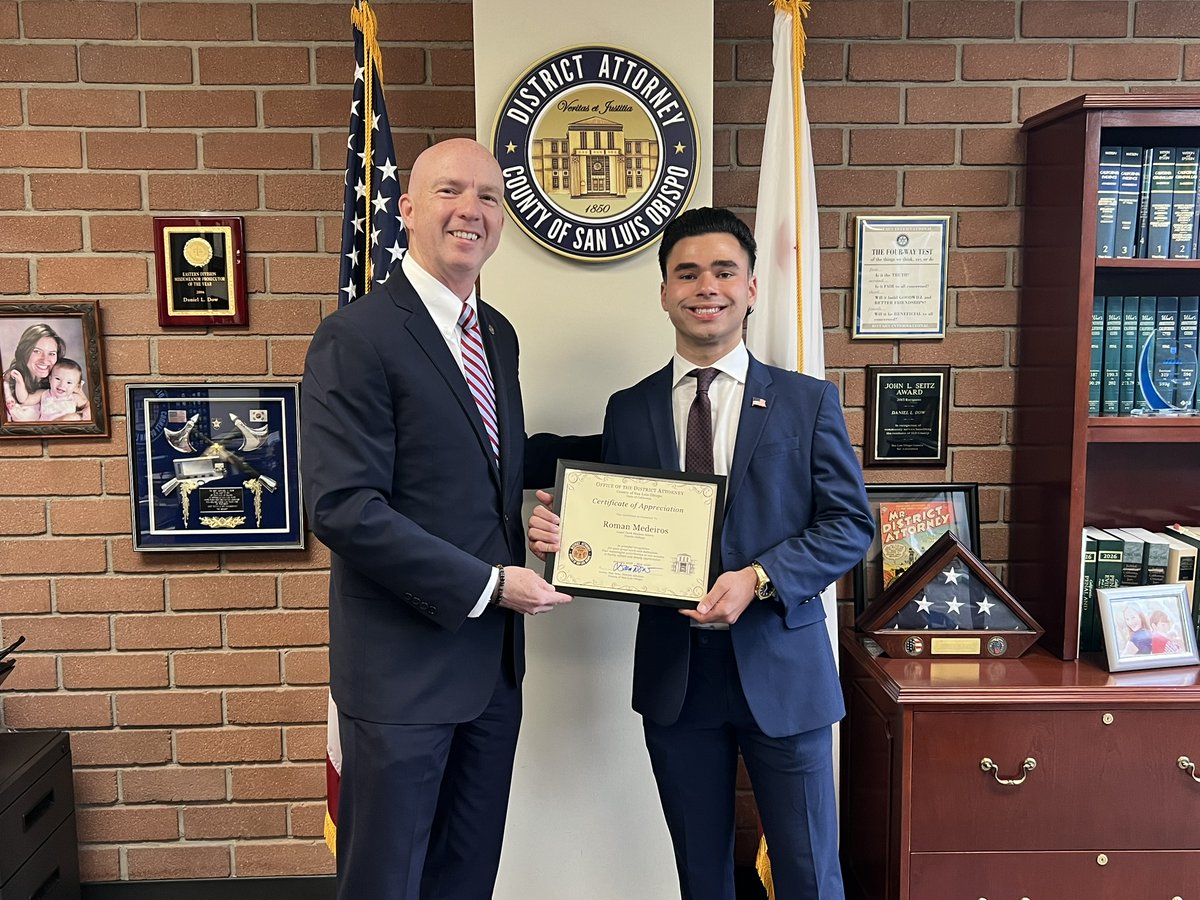 SLOCounty_DA's tweet photo. We recently said farewell to one of our volunteer student interns, Roman Medeiros.  Roman has been volunteering in our office with the Legal Clerk unit since January 2026.  The host of the podcast The Roman Medeiros Show, he currently attends Cuesta College, where he is studying Political Science and hopes to pursue a career in law.  Thank you, Roman, for the help and support you provided staff over the last several months - we wish you the best of luck! 
#slocountyda #slocounty #studentintern
