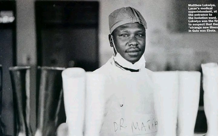 DrOribaDan's tweet photo. In Memory of Dr. Mathew Lukwiya

In his final hours, he spoke to Sister Apio Anyai Angioletta, the paediatric nurse who had known him for years. She would later remember his exact words. 
"Sister, things are worsening. I have tried to fight. The battle is almost over. Now I am seeing that I am also going. The time has come for me to go. That I know. I am going. But if I go, I will be at the doorway. Nobody is going to die now. I will tell my God that enough is enough." 

Then he began to sing a hymn about war. Everyone in the room broke down. Sister Apio replied, "No, doctor, it will not be like that." But it was. On December 4th his breathing briefly stabilised. Later that evening his lungs began to haemorrhage. He died at 1:20am on December 5th, 2000.

He was buried at 4pm the same day. The coffin was sprayed with Jik bleach as it was lowered. Margaret asked if she could see him one last time and was refused. The body was considered too infectious. 

He was placed in a grave he had chosen himself while he was dying, at the Grotto inside the hospital grounds, beside Dr. Lucille Teasdale and later Piero Corti. Teasdale had died in 1996 of AIDS, contracted while operating on an HIV-positive patient. 
The student was buried beside his mentors.

And then something extraordinary happened. After Lukwiya's death, every remaining Ebola patient at Lacor survived. Not another single person died at the hospital. Sister Apio remembered the promise he had made on his deathbed: "I will tell my God that enough is enough." It is the kind of detail you would not believe if you read it in a novel.

By the time the WHO declared Uganda Ebola-free on February 6th, 2001, 425 confirmed and probable cases had been recorded, and 224 Ugandans had died, including thirteen health workers from Lacor alone.

The survival rate during the outbreak was nearly 50%, compared to as low as 10% in previous African outbreaks, largely because of the systems Lukwiya had built before anyone else even knew what was happening.

This is what the mainstream story leaves out. The intern who refused a teaching job in England. The doctor who walked into the bush instead of the nuns. The administrator who turned the hospital into a shelter for nine thousand people, most of them children, every night. 

The Acholi son of a smuggler who topped his country in school, won the John Hay Prize at Liverpool, and still chose Gulu over everything else. By the time he made that final speech to his nurses, the heroism was already the entire shape of his life. The Ebola work only made it public.

Happy Heroes Day, Dr Matthew and all healthcare workers who sacrifice more than they should have to! #HeroesDay

# *Copied*