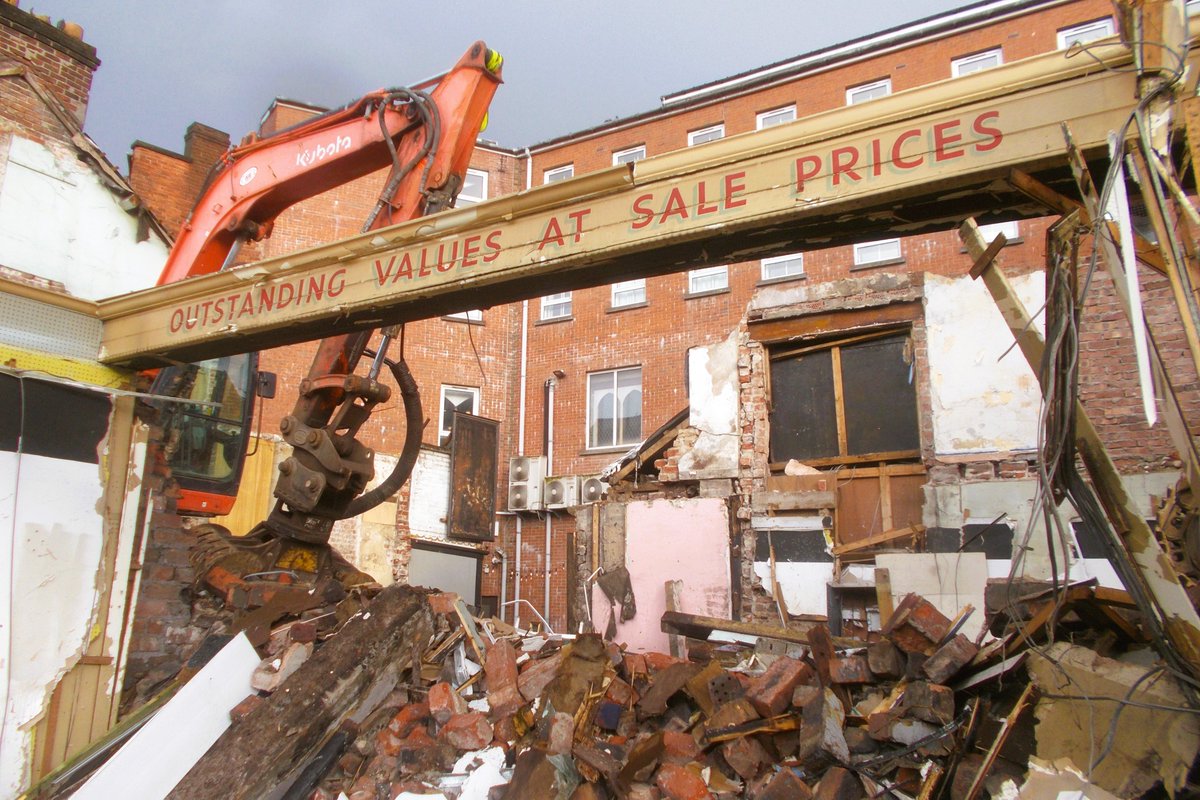 DavidNevin's tweet photo. Donegall Road. The derelict shops next to KFC are being cleared. A ghost sign is temporarily visible - 'Outstanding values at sale prices' https://t.co/eVWll7q51P