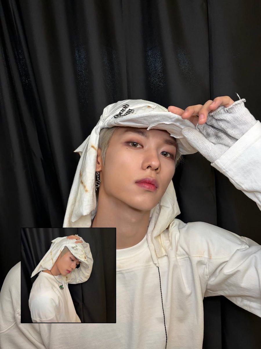 Jeonghyeodn's tweet photo. The side profile cuts a completely different silhouette with the silver hair peeking out from under the heavy headwear. The cool metallic tones mesh perfectly with the stark black curtain backdrop, leaning hard into that futuristic, nomadic warrior aesthetic. https://t.co/8wjVcYtQrO