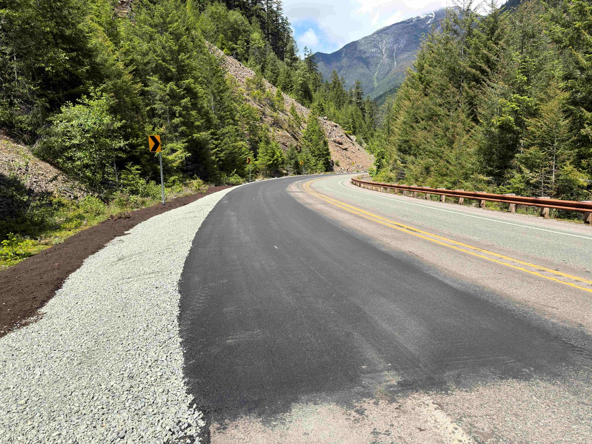 A fresh stretch of asphalt, shoulder rock and mulch along a mountainous stretch of State Route 20/North Cascades Highway.
