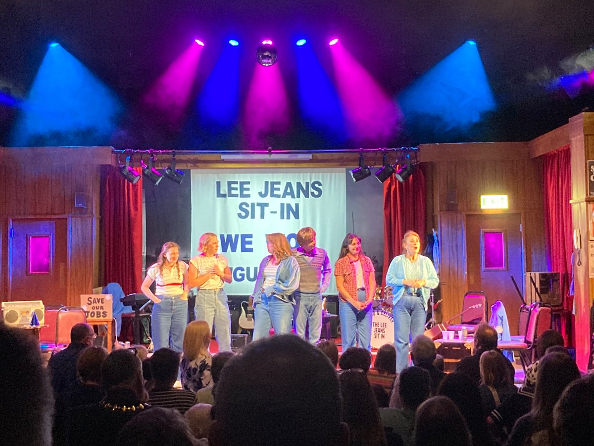PaulEnglishhack's tweet photo. From concept to curtain-up, Stand & Deliver: The Lee Jeans Sit In, which I conceived for @NTSonline and @TronTheatre   with playwright Frances Poet, has been an epic experience in all senses of the word.

Carrying the story of these Inverclyde women (and men) who successfully took on ‘The Man’ onto the national stage, touring the country, has been a long road, and one of the most rewarding things I’ve ever been part of.

I first met these women over a decade ago for an interview in the @Daily_Record, and took their story to NTS with an idea for a play.  We didn’t need to look far for role models when it came to keeping the end of a long haul in sight.  

Working with writer Frances and director @jemimalevick, as well as the most talented cast of actors you could dream of to carry such an important story, has been an unforgettable experience. 

This week’s finale, at Beacon Arts Centre, was performed to several full houses, featuring many of the women from the factory. The atmosphere was hard to describe - having toured around the country, this emotional story of determination, loss, empowerment and community came home to the most unique vibe I’ve ever known in a theatre. 

The multi-talented cast, Aron Dochard, Chara Sparkes, Jo Freer, Maddie Grieve, Shonagh Murray and Hannah Jarret-Scott played, sang and delivered every moment brilliantly, 

‘Greenock’s no bad fae up here.’ 

They’re all Inverclyders, now. Takes one to know one.

#standanddeliver #theleejeanssitin
