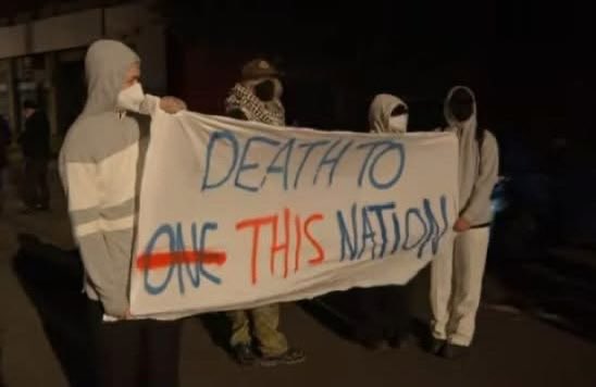 RositaDaz48's tweet photo. #This is not AI, this is real image screen shot from 9 news coverage of the anti racism protests against *One Nation last night, where the Australian flag was destroyed also. 
& your lovely 🤪 .. #senatorMerheenFaruqi was in attendance. 

#These people are *Labor & the *Greens supporters and militant henchmen & are pure evil that hate our own people & country. 

They are Traitors To Australia 🇦🇺. 

#saveaustralia #PutAustraliaFirst
 #OneNation
 #sos