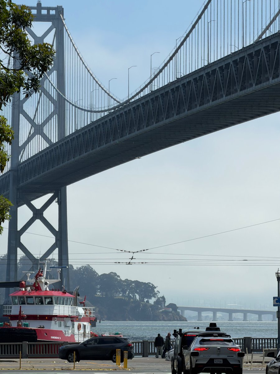 scttcper's tweet photo. It’s hazy today + fireboat. Not sure if it’s World Cup or what but ferry building is packed https://t.co/mzUb8vAYgH