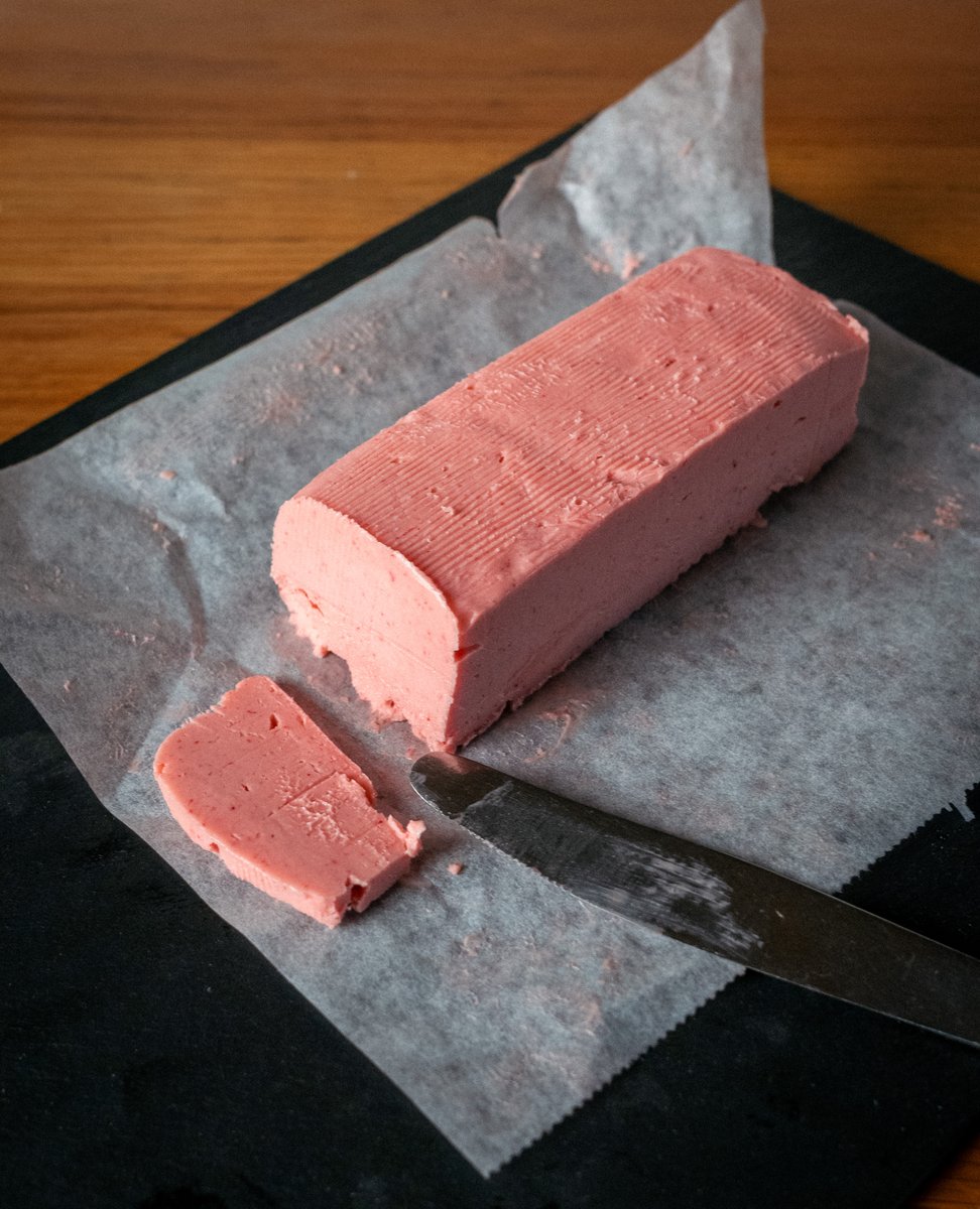 Leon_F_T's tweet photo. It's quite hard to find Raspberry Butter in the grocery store, instead you can easily make your own!

Raspberry Butter Recipe

Ingredients
225 g (1 cup / 2 sticks) unsalted butter, room temperature
100 g frozen or fresh raspberries
2-3 tbsp honey
1-2 tsp lemon juice
1/2 tsp vanilla extract (optional)
Pinch of sea salt (optional)

Directions

Prepare the raspberry compote
Place honey, raspberries and lemon juice in a small pan over medium heat. Bring to a simmer, let raspberries release their juices and collapse. Blend with a hand blender or mash with a fork until smooth. Allow the mixture to thicken, then strain with a sieve to remove seeds. Let it cool to room temperature.

Whip the butter 
Place softened butter in a mixing bowl or a blender. Beat on medium speed for 2-3 minutes until light and fluffy, scraping the sides with a spatula.

Combine
Add the cooled raspberry compote to the whipped butter, with a pinch of sea salt and vanilla if using. Mix on medium speed for 1-2 minutes until fluffy and uniformly pink, scraping the sides with a spatula.

Shape and chill
Spoon the mixture onto a sheet of parchment paper or plastic wrap. Form into a log, roll tightly and refrigerate for 1-2 hours until firm.

Storage 
Keep the log of butter in the fridge for 2-3 weeks, or until original butter's expiry date, and in the freezer for up to 3 months.