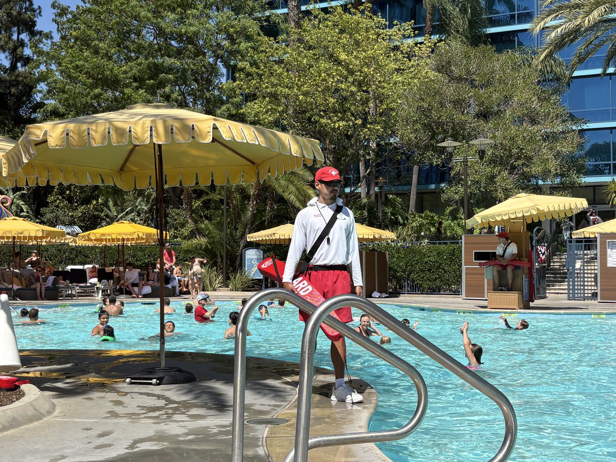 jdandre404's tweet photo. This summer, when you’re sitting by the pool at a Six Flags or a Disney resort, there’s a nine-figure business right in front of you. You’re watching it the entire time and have no idea.

It’s the lifeguards. The ones whose heads never stop moving, scanning the water, making sure nobody’s kid slips under. You can’t miss them. What you’d never guess is the company standing behind them: Ellis & Associates.

They don’t own the park. They don’t run the rides. They don’t even employ most of the guards. They built the standard everyone else has to meet, then sold it to the entire industry.

Here’s how the money actually works.

They train and certify the guards. Ellis wrote the 10/20 Protection Standard, the reason a lifeguard’s head never stops moving. Scan your entire zone in 10 seconds, reach a drowning guest in 20. That constant, never-at-rest discipline you assume is just a serious teenager? It’s a manufactured protocol, drilled and certified.

Then they audit. This is the part nobody knows. Ellis sends auditors who show up unannounced, dressed as ordinary guests, and watch the guards when the guards think no one is. They run vigilance drops, sinking a manikin or a disguised employee into the water to see if the guard catches it in time. Pass or fail, on the record, tied to the facility’s liability.

Now run the math. 700+ client organizations. 1,600+ facilities. Four continents. Recurring training, certification, and audit revenue, plus a risk-management layer no operator can afford to rip out once a drowning lawsuit is on the table. I bet it’s a nine-figure business.

No kid grows up saying they want to build a lifeguard business. No college student, no adult mapping out their career, ever says it either. Yet here’s one worth nine figures.

That’s the whole lesson. If lifeguarding can be worth nine figures, almost anything can. Take real expertise, an unfair advantage most people don’t have, point it at one niche, and become the undisputed best at it. The size of the niche matters less than being the best in it. Do that, and nine figures is on the table no matter how unglamorous it looks.