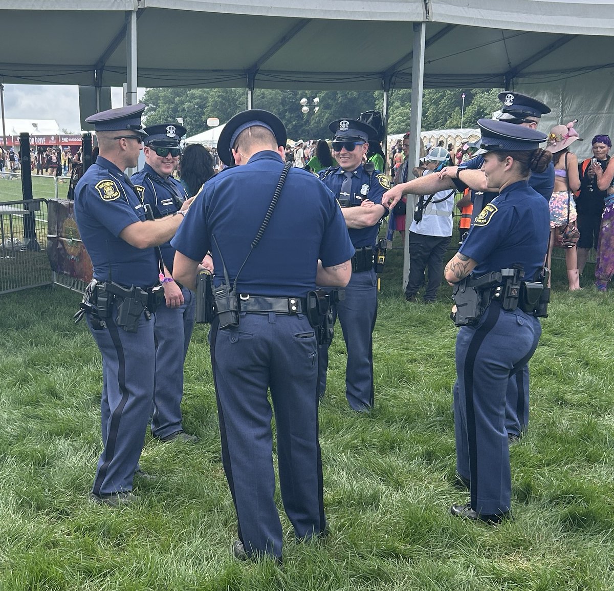 Six Michigan State Police Troopers Talking before their detail starts at the Electric Forest Festival.