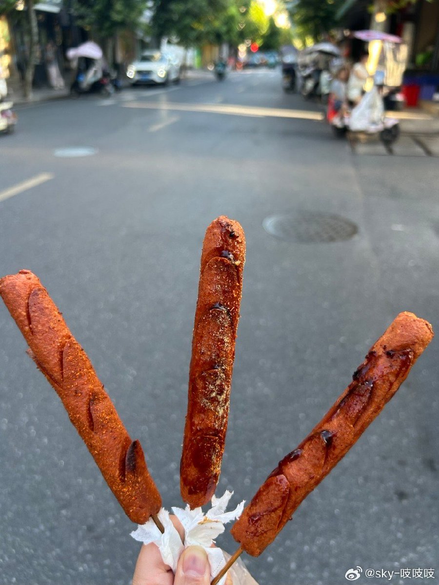Alia_biry's tweet photo. Craving late-night street food Nothing hits like a crispy fried sausage on a stick with sesame seeds from the corner stall—warm, savory, and pure joy! https://t.co/y3DPVUZMl9