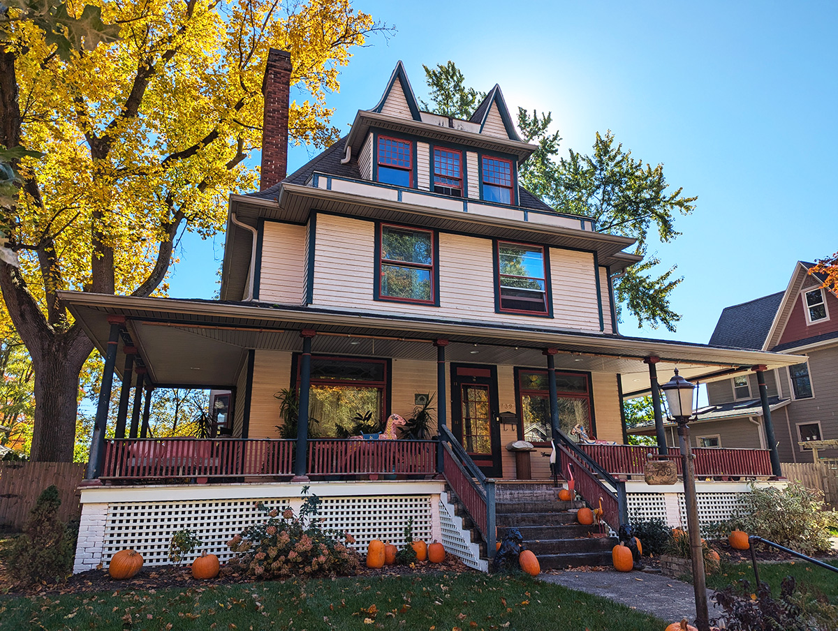 CernunnosF's tweet photo. Two dormers ride this ridge like raised eyebrows. Below them, an American Foursquare in Queen Anne dress and a wraparound porch you could follow the sun around all day — now lined with pumpkins. https://t.co/oxdsaMjJtU #architecture https://t.co/WXx8xyvCWm