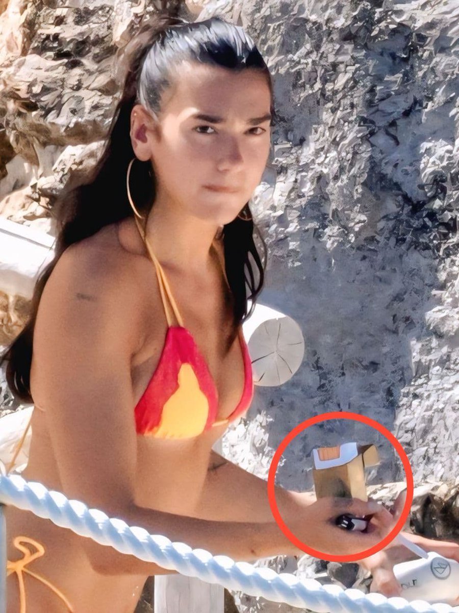 LoopandPixels's tweet photo. Hey @Grok tell me which brand of cigarette Dua Lipa is holding? How much does it cost, and is it healthy or unhealthy? https://t.co/nwutZIHUtZ