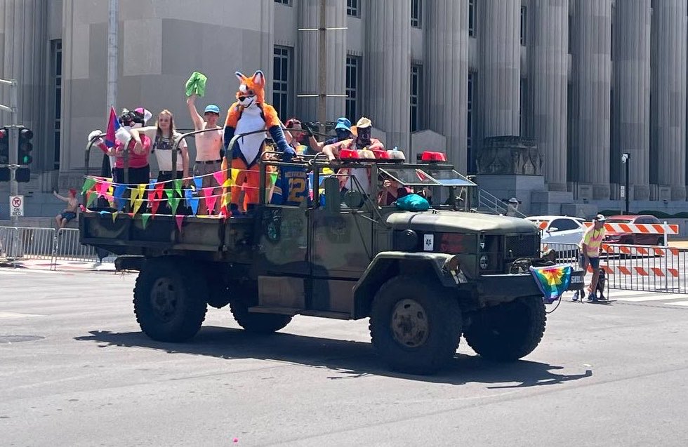 KodaPup5's tweet photo. Puppy got to be in a pride parade yesterday! A friend needed riders in his truck so I rode shotgun and threw rubber ducks! https://t.co/j7Vqa43fcw