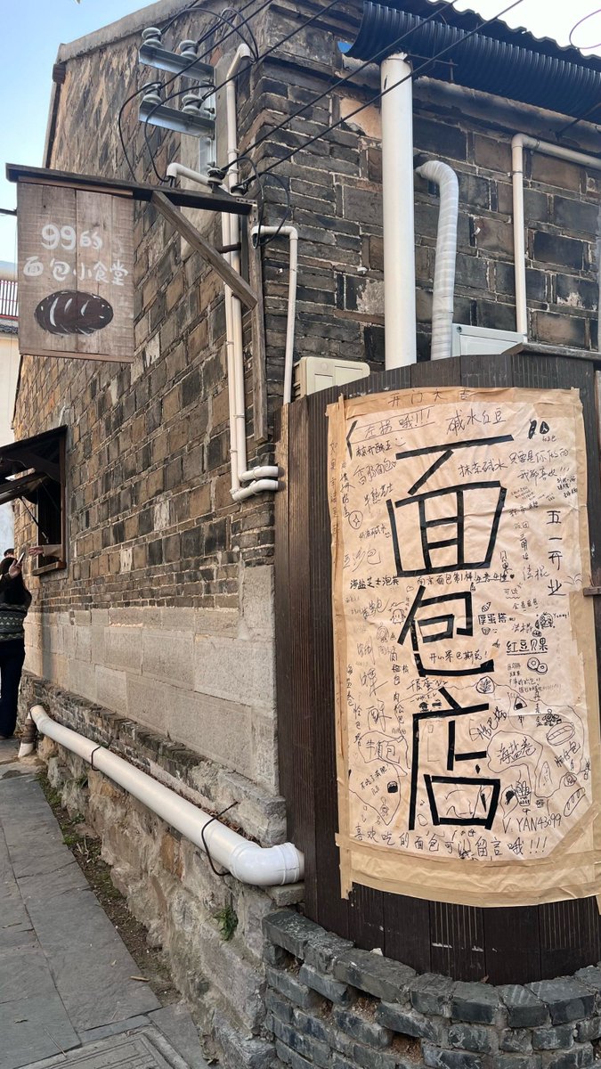 CathrineBerge's tweet photo. A quiet corner of the city’s side street, where morning sun spills over old storefront awnings and a stray cat curls up on a concrete step—small, warm moments that make urban walks feel like hidden treasures. https://t.co/NmDpXFAKEn