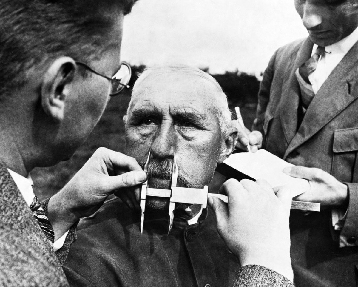 NeSS1889420's tweet photo. Nazi officials use calipers to measure an ethnic German's nose on January 1, 1941. The Nazis developed a pseudoscientific system of facial measurement that was supposedly a way of determining racial descent. https://t.co/brUM7SnJJg