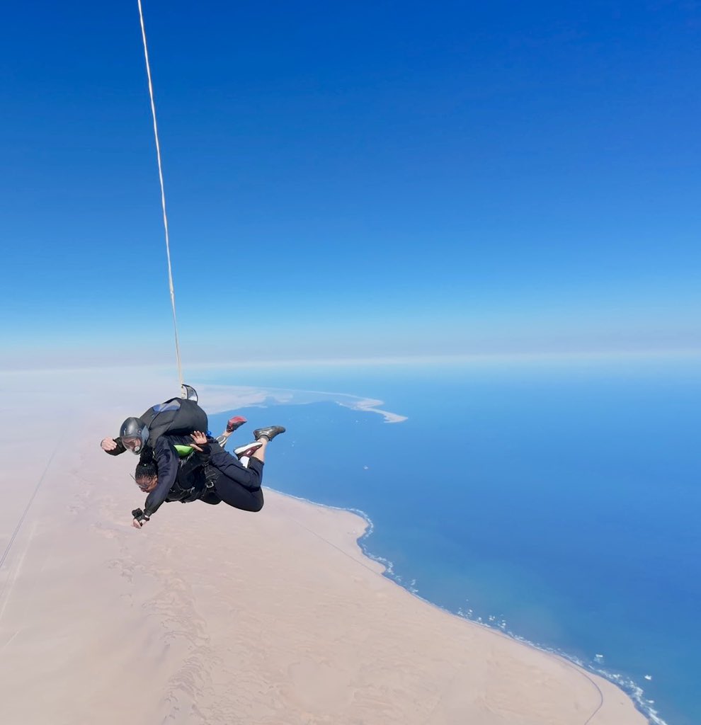 namatai_c's tweet photo. Yesterday, a dream of mine came true: I skydived from 15,000 feet above the Namibian desert and the Atlantic Ocean.

I’ve been to many places and experienced many incredible things, but nothing comes close to the feeling I had while skydiving.

The last frame is a photo of me after I landed. 

In that moment, you could have convinced me that I was an astronaut returning from a mission in space. 

I was still trying to process what had just happened and the fact that something so beautiful could exist.