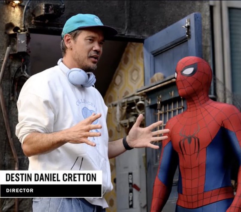 zenisball's tweet photo. the director wearing a challengers sweatshirt and spiderman crashing the wedding from ‘the drama’- everything leads back to the zendaya cinematic universe https://t.co/5u8HUUSZ6R