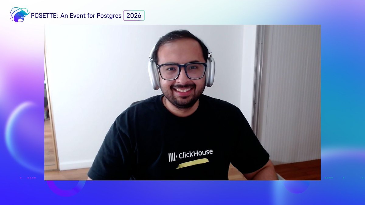 Person wearing headphones and glasses, seated near a window and facing the camera, framed by “POSETTE: An Event for Postgres 2026.”
