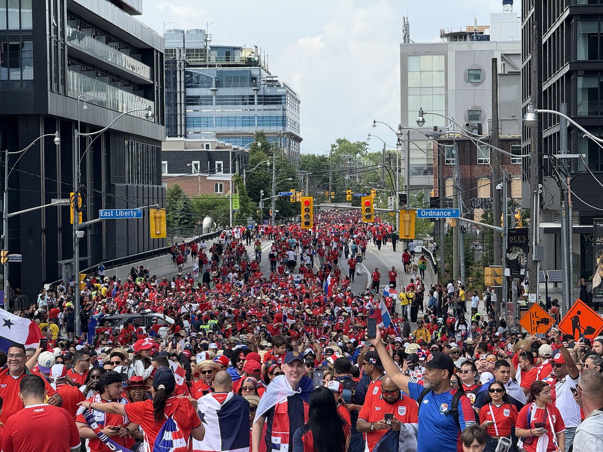 Jerrmainewilson's tweet photo. The Panama supporters march has grown dramatically. What first appeared to be a few hundred fans now looks to be a few thousand people making their way toward the stadium grounds. #FIFAWorldCup #WeAreToronto https://t.co/x1dJZTxaEm