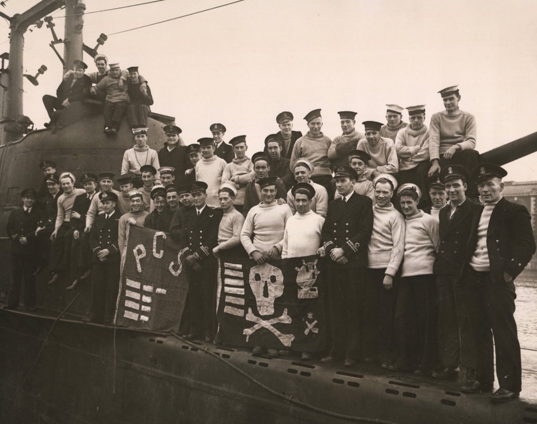 findmypast's tweet photo. Did you know that the Jolly Roger flag wasn't only used by 18th-century pirates? 🏴‍☠️ 

It was later commandeered by crews of Royal Navy submarines and shown off after successful patrols.

📷 Images © Mirrorpix / Reach PLC https://t.co/WAYo5k2dX9
