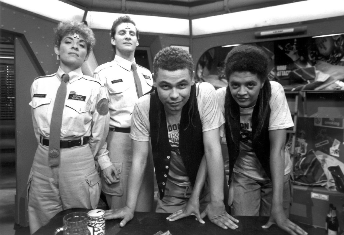 claytonhickman's tweet photo. Just for a change of old-BBC-sci-fi scene, here’s a restored and colourised photo from Red Dwarf. Series 2 (the best series - I will not be taking questions at this time) has hardly any colour photography at all. So now at least there’s one more. Almost.

Suzanne Bertish, Chris Barrie, Craig Charles and Angela Bruce on the bunkroom set in BBC Manchester Studio A on Tuesday 4th October 1988 during camera rehearsals for ‘Parallel Universe’.