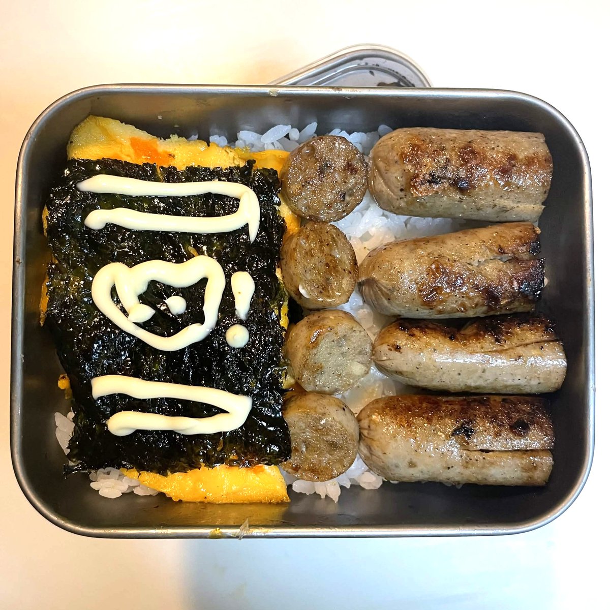rovalcou's tweet photo. Alcoholic hampter made a certified edible bento (?) with a cute hampter drawing on the side. Can you guess what I was trying to do with the sausages? https://t.co/GcjOpJ3V9b