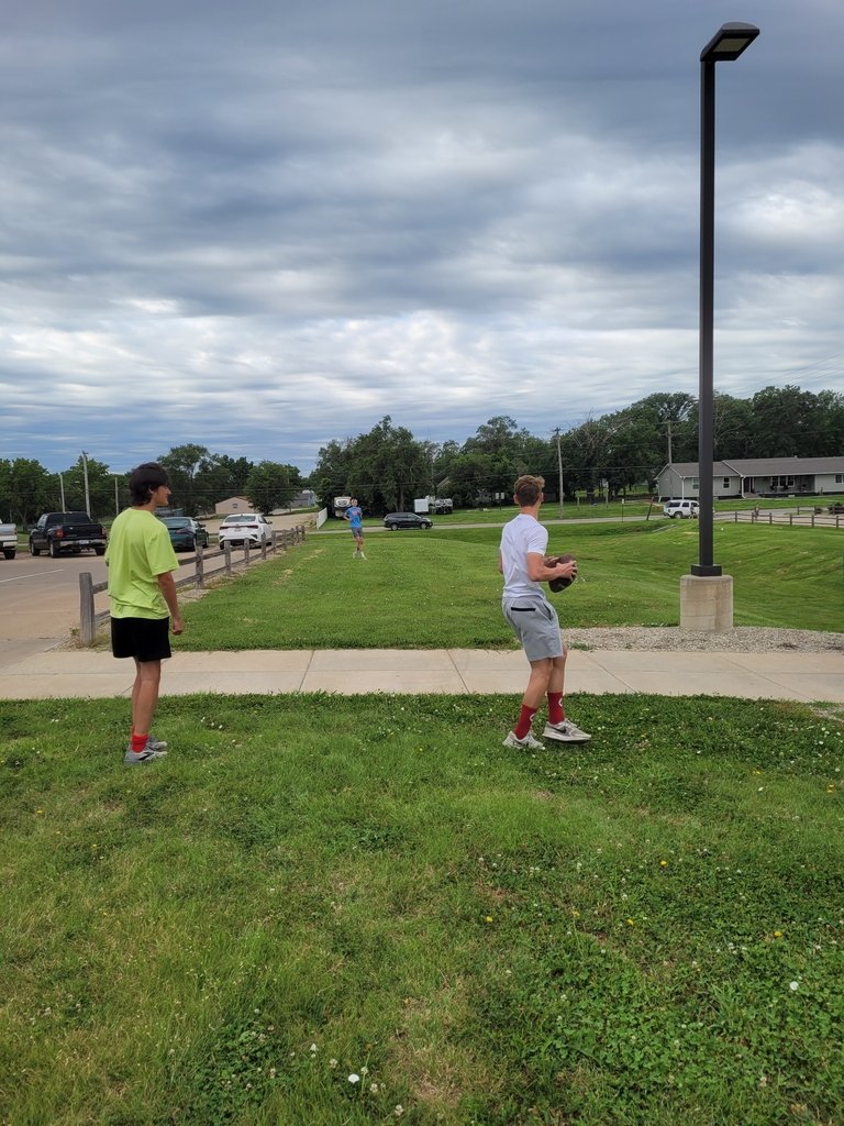 USD239's tweet photo. HS XC runners throwing around the football waiting for their leg of the 50 mile team relay. #LionPride https://t.co/n4CMSPvP9E