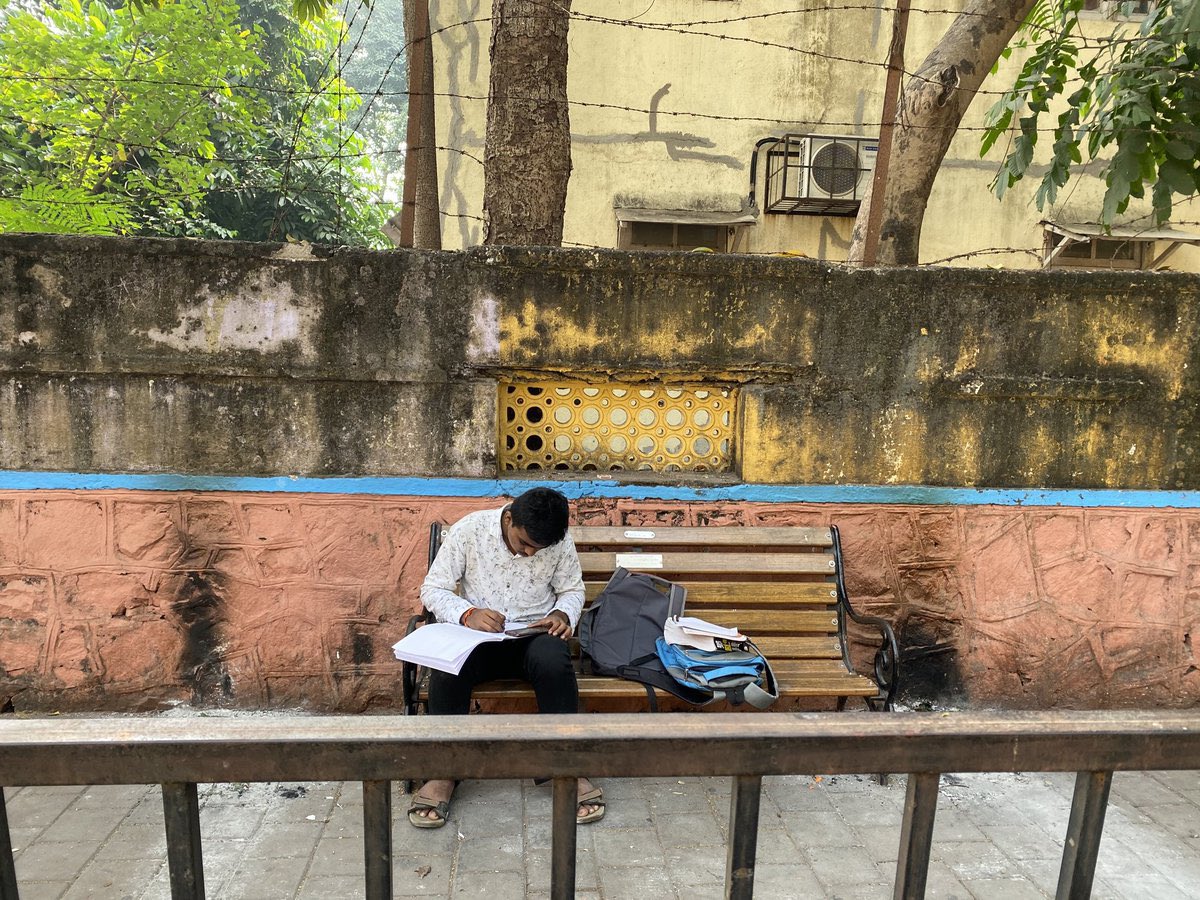 mumbaiheritage's tweet photo. Some time back, I came across an old social media post about a lane in Worli called Abhyas Galli.

The name intrigued me. So today, I decided to visit.

Hidden behind Poddar Hospital and shaded by old trees, the lane appears ordinary during the day. But its story is extraordinary.

For decades, students from the nearby BDD chawls gathered here every evening to study under streetlights. With entire families living in tiny rooms, this quiet stretch of road became their classroom, library and reading room.

So many students studied here over the years that the lane eventually came to be officially known as Abhyas Galli — literally, “Study Lane”.

While searching for its history, I found a few old photographs and scattered references online. Standing there today, it was easy to imagine generations of students sitting beneath these trees, preparing for exams and hoping for a better future.

Mumbai is full of famous landmarks. Abhyas Galli is different.

Its heritage is not in its buildings, but in the dreams that were studied into reality here.

(Some old photographs used in this post were sourced from social media and publicly available online references.)