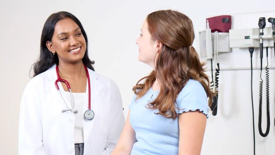 A doctor speaking to a young patient