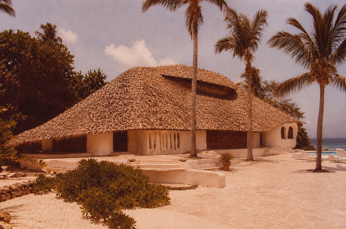 Jason_Jorjani's tweet photo. From mid-1977 into early 1978 Gerald Feinberg, Andrija Puharich, Ira Einhorn, Fereidoun M. Esfandiary, and Buckminister Fuller (among others) attended a series of meetings in this ‘Flintstones’ house that Prince Shahram Pahlavi-Nia had built for the Threshold Foundation on his private island of D’Arros in the Seychelles.

Prince Shahram was the son of Ashraf Pahlavi, and nephew of the Shah of Iran. Princess Ashraf was the real power behind the Pahlavi throne, and at one point even tried to kill her twin brother so that she could become the Shah of Iran herself (she'd have been the first female sovereign since the Sasanian dynasty).

The meetings focused on Prometheus, psychic powers, the future directed evolution of humanity, special children, and the philosophical foundation for an ecological global society destined to expand into the cosmos.

Within a year everything went to hell. An arsonist burned down Puharich’s Lab Nine ‘space kids’ house and he went into hiding in Mexico for fear of the CIA. Einhorn was arrested for murder and claimed that the CIA had framed him. The Pahlavi regime in Iran was overthrown by a CIA plot. The Pahlavi Shahanshah Aryamehr (“Light of the Aryans”) died in exile on July 27, 1980 from the ‘cancer’ given to him by the CIA.

There has been a concerted effort to erase The D’Arros Affair from history. But we are still dealing with its catastrophic consequences today, and they are about to ripple again into the future as a tsunami-sized standing wave.
