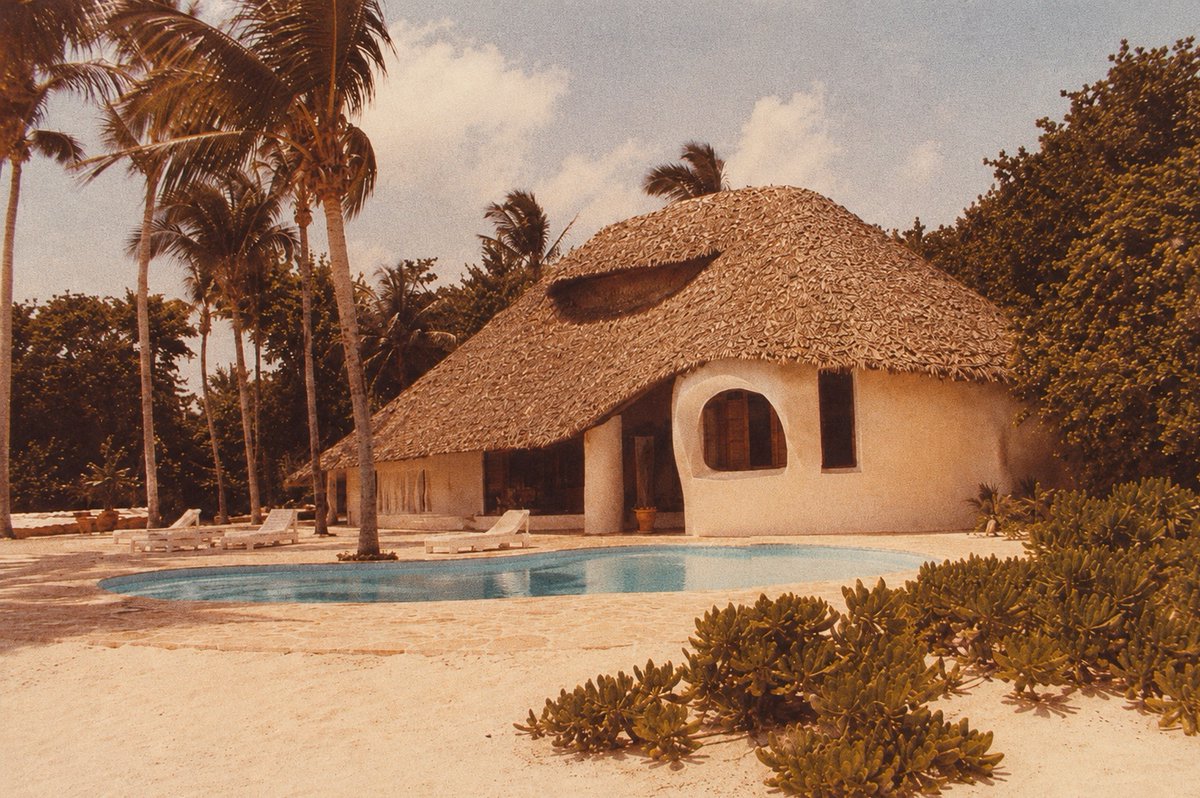 Jason_Jorjani's tweet photo. From mid-1977 into early 1978 Gerald Feinberg, Andrija Puharich, Ira Einhorn, Fereidoun M. Esfandiary, and Buckminister Fuller (among others) attended a series of meetings in this ‘Flintstones’ house that Prince Shahram Pahlavi-Nia had built for the Threshold Foundation on his private island of D’Arros in the Seychelles.

Prince Shahram was the son of Ashraf Pahlavi, and nephew of the Shah of Iran. Princess Ashraf was the real power behind the Pahlavi throne, and at one point even tried to kill her twin brother so that she could become the Shah of Iran herself (she'd have been the first female sovereign since the Sasanian dynasty).

The meetings focused on Prometheus, psychic powers, the future directed evolution of humanity, special children, and the philosophical foundation for an ecological global society destined to expand into the cosmos.

Within a year everything went to hell. An arsonist burned down Puharich’s Lab Nine ‘space kids’ house and he went into hiding in Mexico for fear of the CIA. Einhorn was arrested for murder and claimed that the CIA had framed him. The Pahlavi regime in Iran was overthrown by a CIA plot. The Pahlavi Shahanshah Aryamehr (“Light of the Aryans”) died in exile on July 27, 1980 from the ‘cancer’ given to him by the CIA.

There has been a concerted effort to erase The D’Arros Affair from history. But we are still dealing with its catastrophic consequences today, and they are about to ripple again into the future as a tsunami-sized standing wave.
