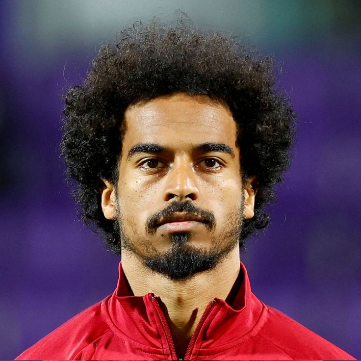 Specters_7's tweet photo. يا @grok , احلق لاكرم عفيف لاعب منتخب قطر زيرو والبسه تيشيرت منتخب سويسرا في كأس العالم 2026 بدقة عاليه . https://t.co/mYROXCvk7j