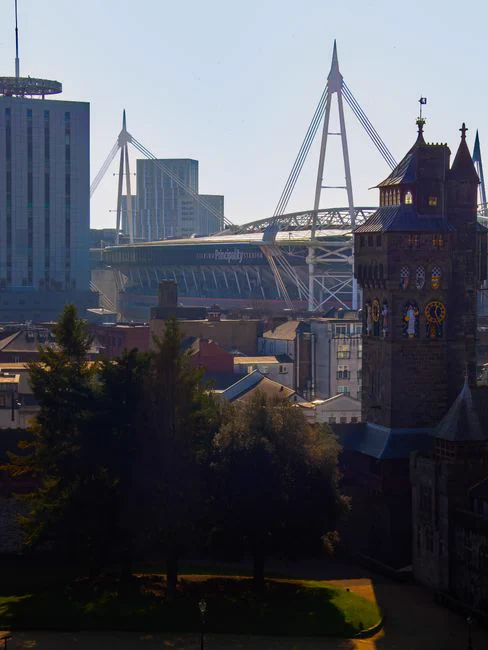 A scenic view of Cardiff highlighting the iconic Principality Stadium and historic architecture.