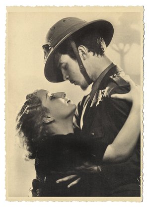ItalianMp3's tweet photo. A romantic scene from the era of Italian colonialism, featuring a soldier in uniform embracing a woman. https://t.co/AKXNSlkyU8