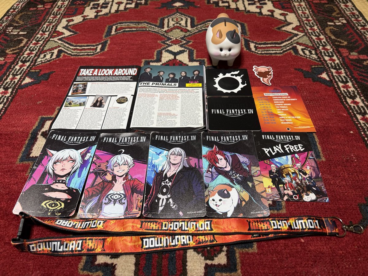 F_Freeeman's tweet photo. Part 5 – What I brought home from Download Festival 2026.

After returning to Japan, I finally had time to lay everything out and look back on an unforgettable weekend.

From official Download Festival merchandise, to exclusive FFXIV booth items, guitar picks, stickers, a Fat Cat coin bank kindly gifted to me by a fellow Warrior of Light who won it at the FFXIV booth claw machine, and other souvenirs from the event — every item reminds me of the amazing people I met and the memories I made.

Some of these items will be kept as treasured souvenirs, while others will be shared with friends who support THE PRIMALS and FFXIV.

Thank you to everyone who made this experience special.

#PrimalsDownload #DLXXIII
#THEPRIMALS #FFXIV