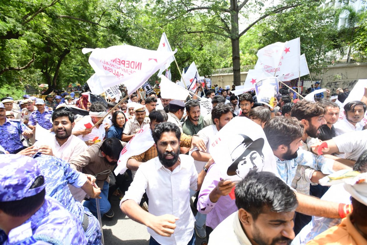 cpimspeak's tweet photo. The Students Federation of India led a militant protest march to the Ministry of Education in New Delhi today demanding the immediate resignation of Dharmendra Pradhan, scrapping of the National Testing Agency, decentralization of examinations, independent judicial probe into the NEET and CBSE scams, punishment of all culprits, and fair compensation for all affected students. Hundreds of students from different states resolutely marched forward despite the heavy deployment of police forces and barricades along the march route by the Delhi Police, raising slogans against the anti-student policies of the BJP-RSS-led government and demanding accountability for the unprecedented collapse of educational governance under Dharmendra Pradhan's tenure.

A four member delegation comprising SFI All India General Secretary Srijan Bhattacharyya, President Aadarsh M Saji, Joint Secretary Aishe Ghosh and Vice President Shilpa proceeded to the Ministry of Education and submitted a memorandum demanding  the immediate resignation of Dharmendra Pradhan and highlighting the severe crisis confronting students across the country. The delegation emphasized that recurring paper leaks, examination irregularities, arbitrary administrative decisions, and the government's failure to ensure transparency and accountability have severely undermined the credibility of the education system.

The delegation also issued a clear ultimatum stating that if Dharmendra Pradhan fails to resign and if the Government of India does not address the demands raised by students across the country, SFI will intensify its agitation until justice is secured for all affected students. The protesters resolved to mobilize students nationwide in the coming weeks and to strengthen the struggle on the streets in order to defend students’ rights and save public education.