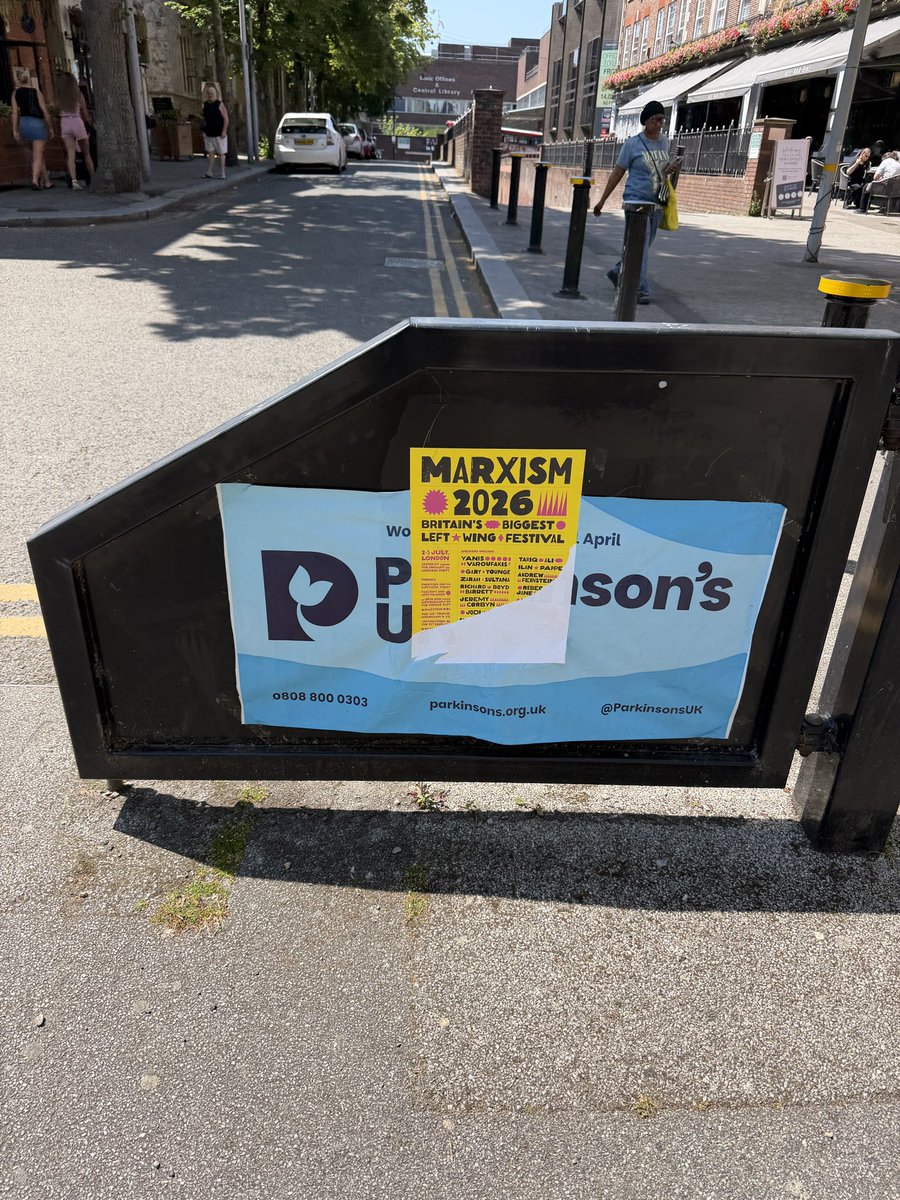 MrMKimber's tweet photo. Nothing says ‘progressive values’ quite like wallpapering over a charity poster to make room for Marxism https://t.co/XJNFRdECQM