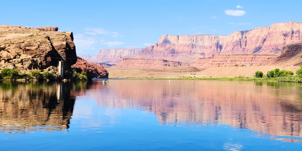 he Colorado River at Lees Ferry. The Lees Ferry streamgage is visible at the base of the cliffs on the left sides of the photo. Photo by the USGS