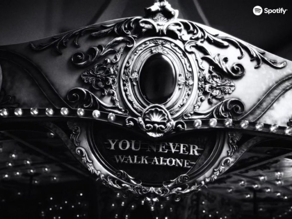 kthnoir7's tweet photo. In this mv, Members showed them reflecting on the years they spent separated from their real world, while asking whether the cycle that shaped them is a prison or a home.
I thought it in 3 parts.

1. The literal layer: military service
The endless corridors, identical rooms, flickering lights, repetitive movement, monochrome palette, and the carousel all mirror military life.
A merry-go-round moves constantly but never truly goes anywhere.
You wake up. Repeat the routine. Another day passes. Repeat.
The ride keeps moving, but you have no control over its speed or direction.
This is why the military imagery and carousel imagery feel fused together.

2. The psychological layer: each member confronting his own "shadow"
This is where the Jungian theory and Fake Love connections become important.
The rooms don't feel like physical locations.
They feel like internal spaces.
RM → awake room, insomnia, endless thinking.
Jimin → chasing the carousel/old memories.
Yoongi → storm, flying papers shows chaos, public scrutiny.
Jin → crossing the corridors while darkness follows him as if He's trying to get rid of smtg (pain/past self or pathetic memory) but it keeps following him. Cause The black liquid is probably not a monster.
It resembles what Jung calls the shadow: fear, guilt, loneliness, grief, exhaustion,entment.
You can leave the room.
But the shadow follows.
Notice how it never truly defeats them.
It simply exists.
That's a very BTS message.
Not "we conquered pain."
More:
★We carried it with us and kept moving.

3. The meta layer: BTS's entire career as a loop. This is where HYYH, Spring Day, YNWA, Fake Love, Monochrome, Proof, and even the solo era connect.
The carousel isn't just military service.
It's BTS itself.
A cycle of:
★debut
★growth
★success
★sacrifice
★separation
★reunion
★new beginning
over and over.
The spaceship, infinity imagery, doors, corridors, alternate rooms, and references to past eras suggest BTS are traveling through their own history.
Not escaping it.
Revisiting it. 

BTS constantly open doors themselves.
Throughout their career:
HYYH
Wings
Love Yourself
Map of the Soul
Proof
now Merry Go Round
doors appear whenever a new chapter begins.
The message seems consistent:
★Nobody opened these doors for us. We walked through them ourselves.
In Merry Go Round, the doors feel like eras, memories, and possible futures.
Each room contains a different version of BTS.
Jin and Taehyung
This is the most interesting part.
If viewed through HYYH:
Taehyung is often the first to sense something is wrong.
Jin is the one burdened with correcting the timeline.
In Merry Go Round, it almost feels like a passing of responsibility.
Taehyung disappears as Jin arrives.
Not because they're enemies.
Because their roles are changing.
Almost like:
"I've been holding this place while you were gone. Now you're back."
Considering Jin was the first member discharged, this reading works both symbolically and emotionally.

Why Jimin follows the carousel?
Not because he's trapped.
Because he's afraid of losing what the carousel represents.
The carousel is:
BTS
youth
memories
togetherness
He isn't chasing a ride.
He's chasing a promise.
The same promise from Spring Day:
No matter how long winter lasts, we'll meet again.
The actual ending
This is where I disagree with the "they escaped the loop" theory.
I don't think they escaped.
I don't think they wanted to.
The final message feels closer to:
★We discovered that the loop itself wasn't the enemy.
The military years ended.
The loneliness ended.
The waiting ended.
But BTS will always be riding another merry-go-round:
new albums, new eras, new challenges, new universes.
The difference is that now they're riding it together again.
That's why the MV feels strangely hopeful despite all the darkness.
The ending doesn't say:
"The ride stopped."
It says:
"We're all back on it now."
& for BTS, that is home.