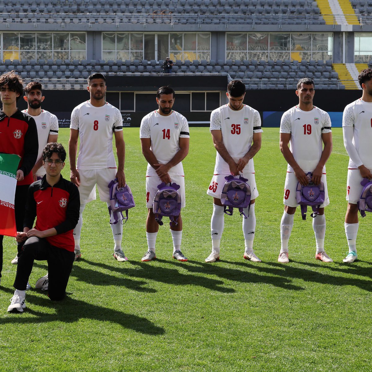 landpalestine's tweet photo. Iran team holds schoolbags in tribute of 168 girls killed the by United state https://t.co/e6iUAXV9Bc