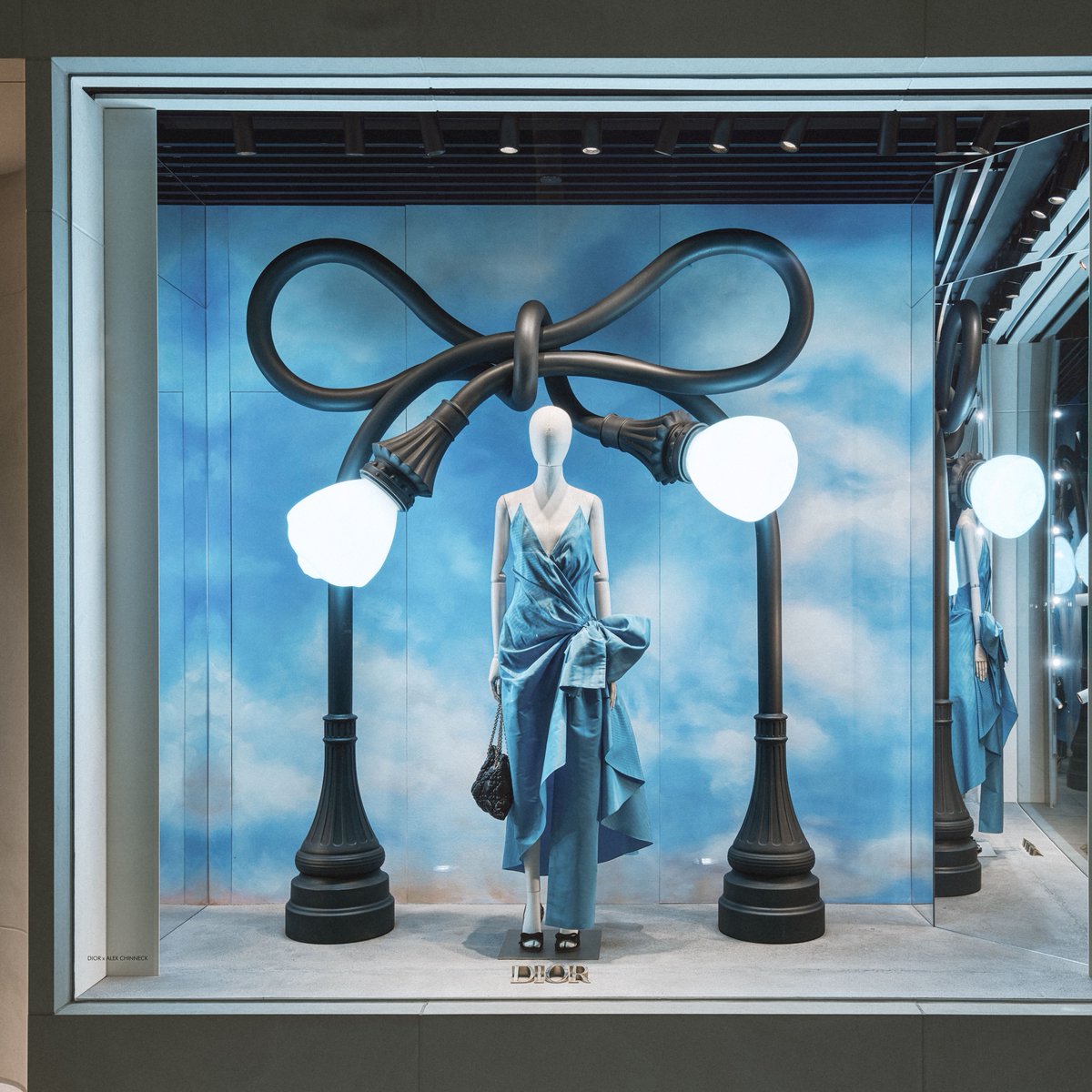 Dior's tweet photo. Artist Alex Chinneck reimagines urban icons from New York and Los Angeles as surrealist sculptures at their respective House of Dior locations. Come visit us to discover the nine works animating the windows on 57th Street, while five more continue the showcase in Beverly Hills.
