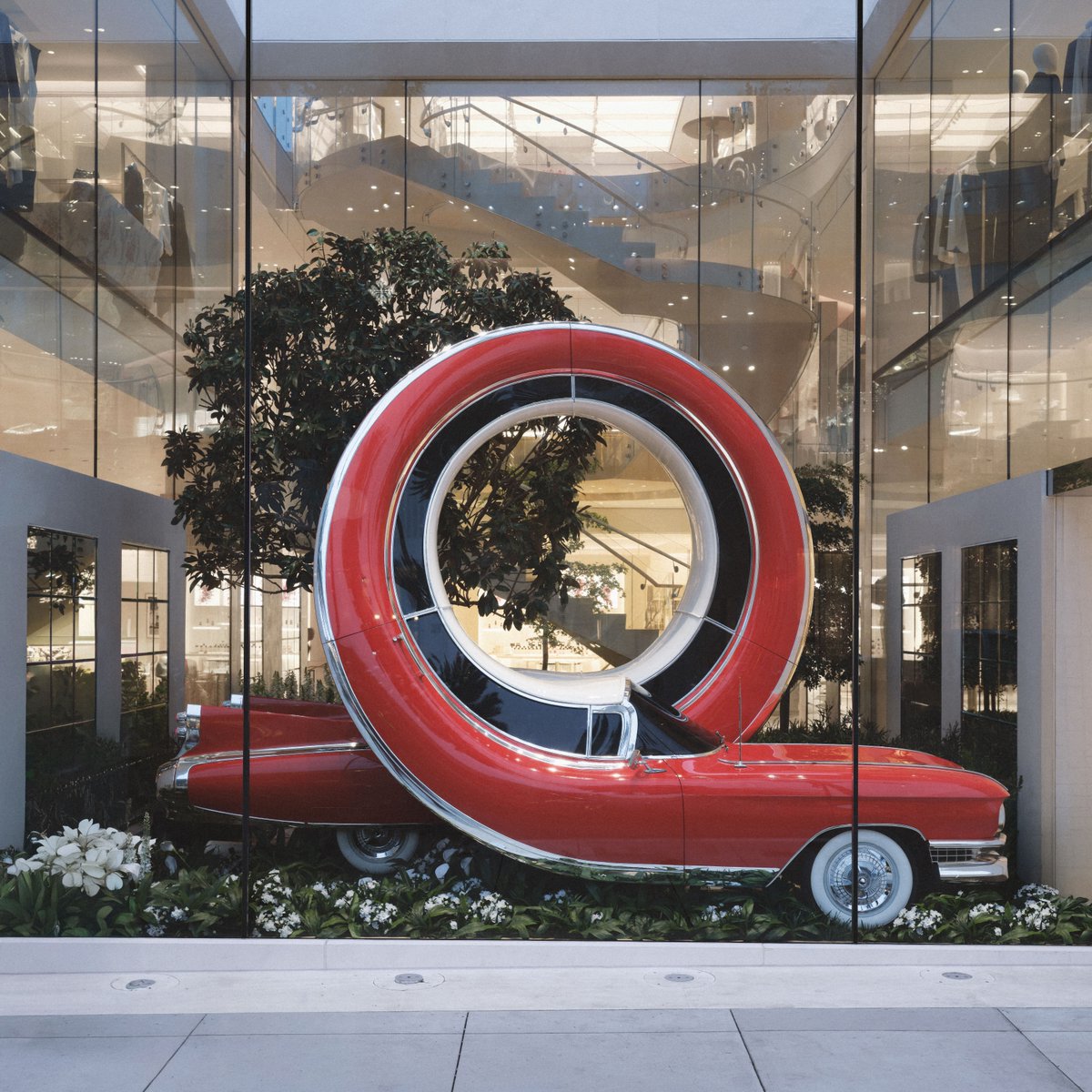 Dior's tweet photo. Artist Alex Chinneck reimagines urban icons from New York and Los Angeles as surrealist sculptures at their respective House of Dior locations. Come visit us to discover the nine works animating the windows on 57th Street, while five more continue the showcase in Beverly Hills.