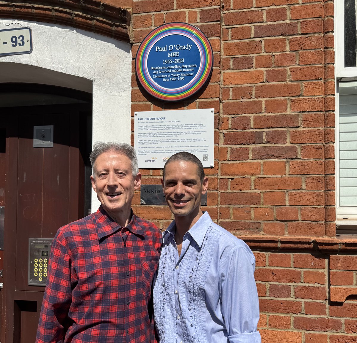 PeterTatchell's tweet photo. Rainbow Plaque unveiled in memory of Paul O’Grady. Victoria Mansions, South Lambeth Road SW8 

Before his death, Paul championed our #ApologiseNow campaign, which eventually got 22 police chiefs to say sorry for past witch-hunts 

Photo: With Paul���s husband Andre Portasio https://t.co/ejor4ZvREt