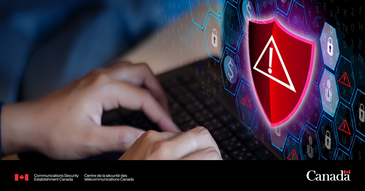 Hands on a laptop keyboard. There's an alert sign on screen.