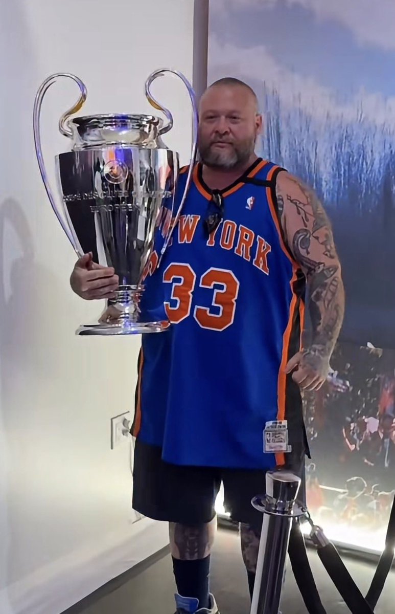 ByDobson's tweet photo. Action Bronson holding the Champions League Trophy (2026). https://t.co/ERoVrm7ZT5