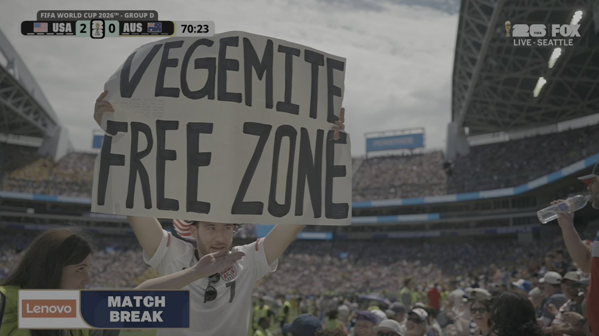 usmntonly's tweet photo. A USMNT fan holding a 'VEGEMITE FREE ZONE' sign during the USA vs. Australia World Cup match 😭 https://t.co/R5RIVmFIc1