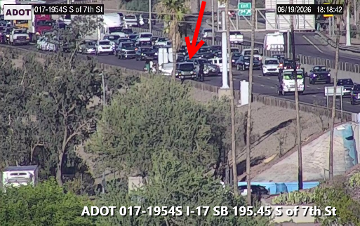 A crash blocks lanes on a highway. A red arrow points to one of the vehicles involved.