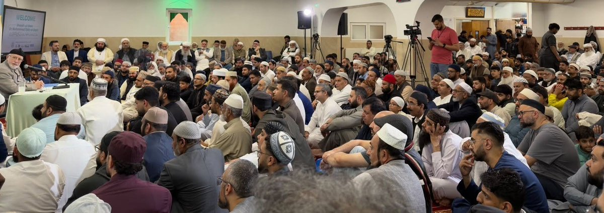 TahirulQadri's tweet photo. Nelson, UK: Shaykh-ul-Islam Calls for Mandatory Urdu Education to Safeguard Future Generations at Suhbah Gathering

A spiritually uplifting Suhbah gathering was held at Jamia Masjid Minhaj-ul-Quran Nelson in the blessed company of His Eminence Shaykh-ul-Islam Dr Muhammad Tahir-ul-Qadri. Families, elders, youth and community members gathered for Zuhr Salah followed by a profound Naseeha addressing one of the most pressing challenges facing Muslim communities in the West: preserving faith, identity and Islamic knowledge for future generations.

Opening his address with a clear policy statement, Shaykh-ul-Islam declared that Urdu should be established as a mandatory second language across Islamic centres and mosques without delay. His Eminence emphasised that this was not simply a matter of language, but a strategic necessity for preserving access to Islamic scholarship, religious understanding, spiritual etiquette and cultural continuity.

Shaykh-ul-Islam informed attendees that Minhaj Education Society has already developed educational programmes and learning resources specifically designed for Muslim children growing up in Western and European societies. These include Islamic stories, educational content and structured language programmes which centres can immediately adopt and implement.

Explaining the significance of language, His Eminence distinguished between its two primary functions: communication and transmission. Communication facilitates the short-term exchange of information between people, whilst transmission enables knowledge, values, traditions and identity to be passed from one generation to the next.

Shaykh-ul-Islam stressed that the issue of Urdu is not merely linguistic. Rather, it concerns access to religious knowledge, Islamic heritage, spiritual etiquette and the accumulated scholarly legacy of the Muslim Ummah. Whilst losing Urdu does not remove a person from Islam, His Eminence warned that it significantly weakens the transmission of faith, emotional attachment to religion and access to deeper Islamic learning.

Presenting a detailed overview of Islamic scholarship across languages, Shaykh-ul-Islam explained that Arabic contains 100% of the original Islamic sources, including the Holy Qur’an, Hadith, Tafseer and Fiqh.

His Eminence further noted that approximately 25% to 35% of Islamic literature is available in Turkish due to centuries of Seljuk and Ottoman patronage. A similar 25% to 35% is available in Persian owing to the contributions of major Muhadditheen, Mufassireen, scholars and Awliya, including figures such as Imam al-Ghazali.

Shaykh-ul-Islam stated that Urdu possesses an equally rich scholarly heritage, containing approximately 25% to 35% of the wider Islamic corpus. As a result, Urdu serves as a unique bridge through which Muslims of South Asian heritage can access a vast reservoir of religious knowledge.

By contrast, His Eminence explained that German, Spanish and French collectively contain only around 3% to 4% of translated Islamic content, whilst most other European languages contain between 1% and 2%.

Regarding English, Shaykh-ul-Islam explained that only approximately 10% to 18% of Islamic literature is available, with an average of around 14% to 15%. This means that an English-only reader remains disconnected from approximately 85% of the wider Islamic scholarly tradition.

His Eminence further cautioned that the issue is not merely one of quantity but also quality. Whilst translations of certain texts are available, many classical commentaries, scholarly explanations, methodologies, jurisprudential principles and advanced works remain inaccessible in English. Consequently, reliance upon English alone can leave students of knowledge disconnected from the depth and breadth of the Islamic intellectual tradition.

Shaykh-ul-Islam drew attention to the increasing influence of social media and online platforms, warning that many young Muslims are receiving religious guidance from unqualified individuals who possess neither scholarly training nor recognised authority. His Eminence stressed that Islamic knowledge cannot be acquired through isolated reading or internet content alone, just as a person cannot become a doctor, engineer or lawyer merely by purchasing textbooks.

A significant portion of the address focused on the relationship between language, culture and adab. Shaykh-ul-Islam explained that every language carries within it a system of manners, values and social conduct. Urdu, in particular, preserves concepts of respect, honour and reverence through its vocabulary and modes of expression.

His Eminence illustrated how language shapes behaviour towards parents, elders, teachers and scholars. When heritage languages are lost, the culture of respect and refinement carried within those languages gradually weakens. As a result, future generations may retain the name of Islam whilst losing much of its spiritual taste, inherited etiquette and emotional connection.

Shaykh-ul-Islam explained that faith, language, culture and society are reciprocally interconnected. Each reinforces the other and collectively contributes to the preservation of religious identity. When one element weakens, the others are affected.

Expressing deep concern for the future, His Eminence warned that within two generations many Muslim communities in the West risk losing meaningful connection with their faith unless urgent action is taken. He observed that parents often dedicate immense effort towards their children’s worldly education and careers whilst comparatively little attention is given to preserving religious identity, knowledge and spirituality.

Using powerful examples, Shaykh-ul-Islam reminded attendees that the true protection of children lies not in seeking solutions after problems emerge, but in investing in their tarbiyyah from an early age. Religious upbringing, Islamic knowledge, a strong home environment and access to authentic scholarship remain the greatest safeguards for future generations.

His Eminence also announced that this subject forms part of a wider series of seven lectures addressing different aspects of the challenge facing Muslims in the West. Future discussions will examine the responsibilities of parents, homes, mosques, scholars and wider society in preserving faith and identity.

Concluding his address, Shaykh-ul-Islam reminded attendees that investing two or three years in learning Urdu can yield benefits for generations to come. Preserving Urdu, His Eminence explained, is not about language alone; it is about maintaining access to knowledge, adab, spiritual heritage, scholarly depth and a living connection to the faith.

The gathering concluded with a renewed commitment amongst attendees to prioritise the religious upbringing of future generations and to strengthen the means through which Islamic knowledge, values and identity are transmitted in the modern world.

#ShaykhUlIslam #DrTahirUlQadri #MinhajUlQuran #MQINelson #MQIUK #Suhbah #Urdu #IslamicKnowledge #IslamicEducation #Tarbiyyah #Adab #FaithPreservation #MuslimYouth #BritishMuslims #MinhajEducationSociety #PreservingFaith #IslamicHeritage